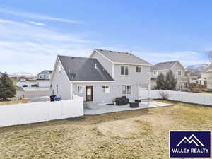 Back of house featuring a patio, outdoor seating, a fenced backyard, a residential view, and a mountain view