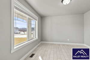 Front room featuring wood tiled floors and baseboards