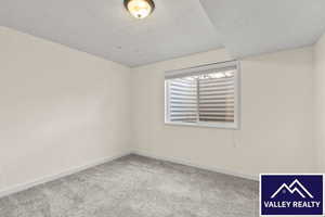 Unfurnished room with light carpet and baseboards