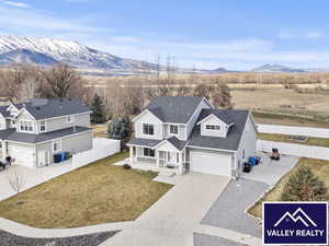 Traditional-style house featuring driveway, a porch, and a mountain view