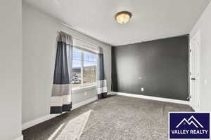 Spare room with light colored carpet and baseboards