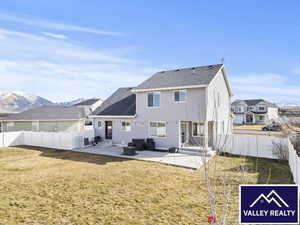 Back of house featuring a patio area, an outdoor hangout area, a fenced backyard, and entry steps