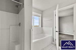 Full bathroom featuring a stall shower, a garden tub, light colored carpet, and light tile patterned flooring