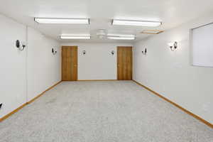 Unfurnished room with a ceiling fan and light carpet