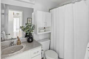 Full bath with vanity and a shower with curtain