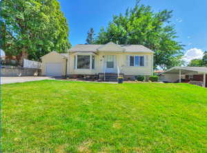 View of front of house featuring a front yard and concrete driveway