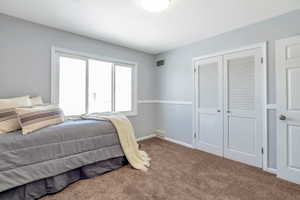 Bedroom with carpet flooring and a closet