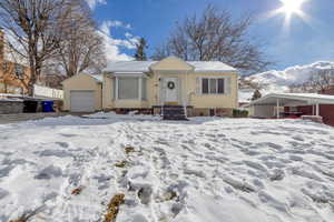 View of front of house featuring an outdoor structure and a garage
