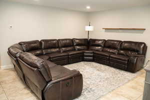 2nd family room with recessed lighting and light tile patterned floors.