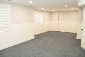 Oversized room used as a bedroom with plenty of natural light.