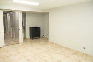 Large tiled room with endless possiblities. Is plumbed and was used as a hair salon.