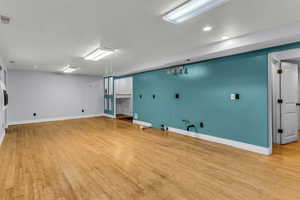 Walk-out  basement featuring light wood-style floors and recessed lighting