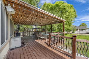 Deck featuring a yard, outdoor dining space, and grilling area