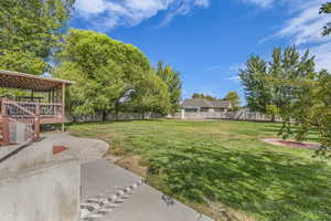Fenced backyard featuring a deck and a patio area