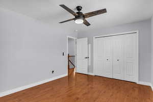 Unfurnished bedroom featuring a closet, a ceiling fan, LVP flooring