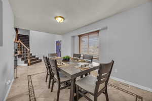 Dining space with inlaid floor details patterned Travertine flooring