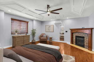 Bedroom with LVP flooring, a premium fireplace, a ceiling fan, and recessed lighting