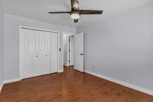 Unfurnished bedroom featuring a closet, ceiling fan, and LVP flooring