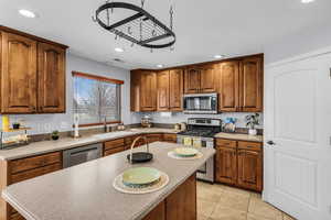 Kitchen with wood finish cabinetry, stainless steel appliances, recessed lighting,