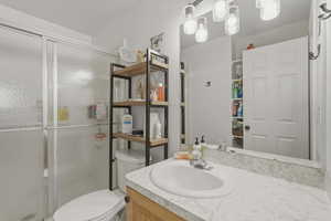 Bathroom with vanity and a stall shower
