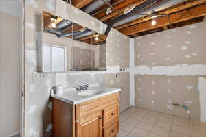 Bathroom with vanity and light tile patterned flooring