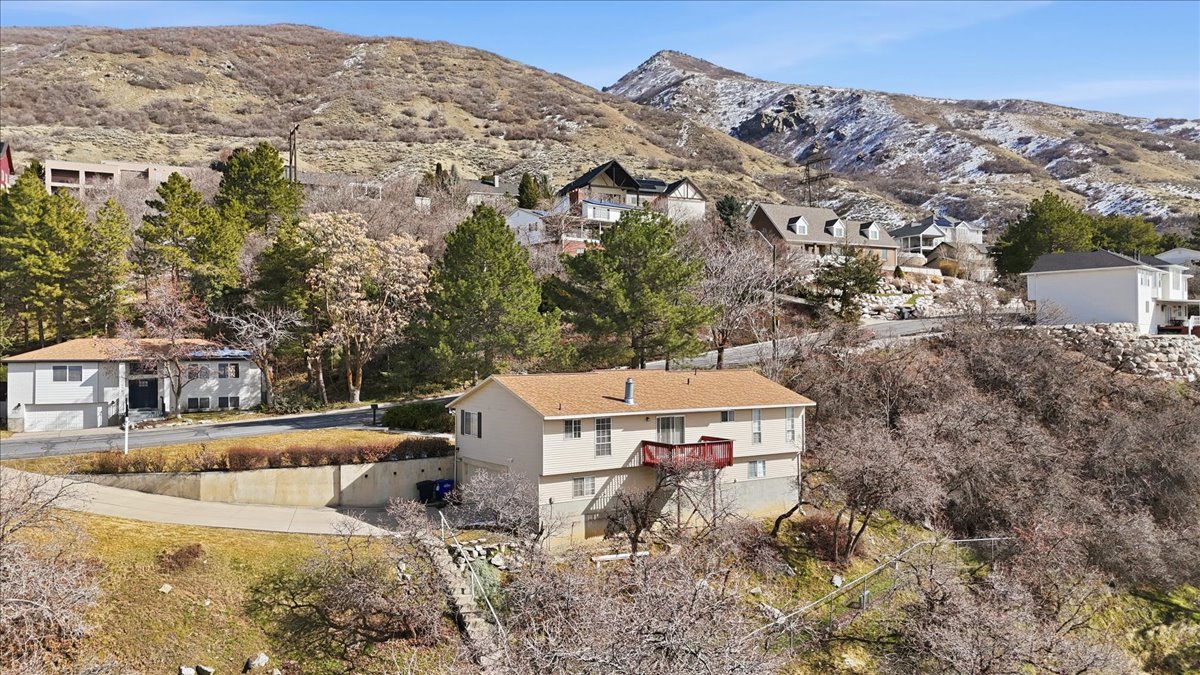 Aerial perspective of suburban area featuring a mountainous background