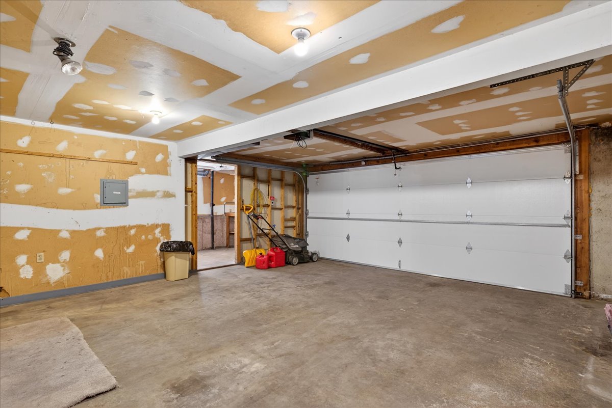 Garage with a ceiling fan and electric panel
