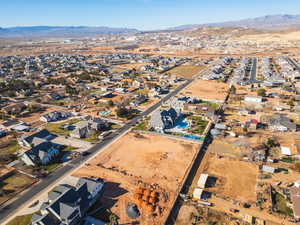 Aerial view of property's location with nearby suburban area and mountains
