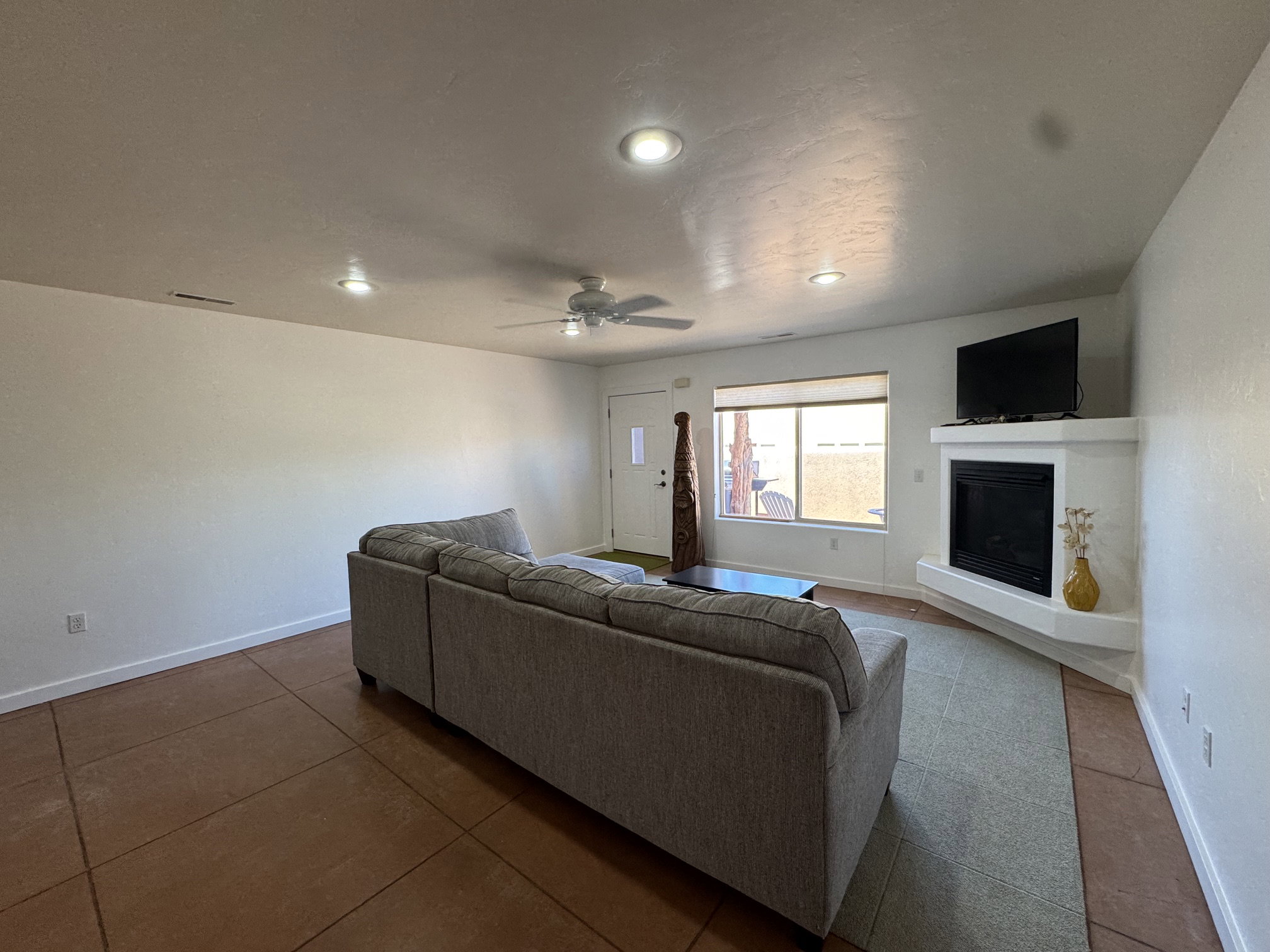 Living space featuring recessed lighting, a ceiling fan, and a built-in corner gas fireplace with a tv mantel