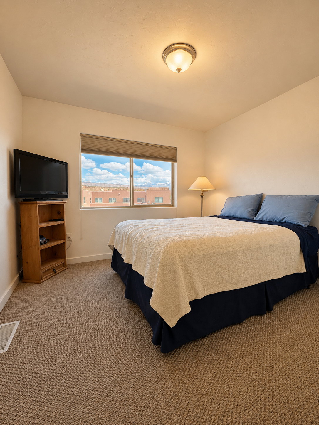 Guest bedroom with queen bed and mountain views