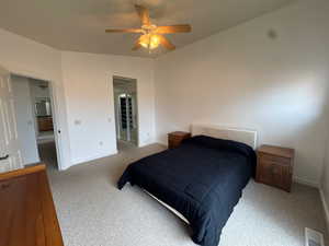 Bedroom featuring carpet flooring, ceiling fan, and lofted ceiling