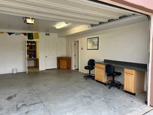 Garage with a desk and a garage door opener