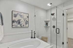 Full bathroom featuring a stall shower and a garden tub