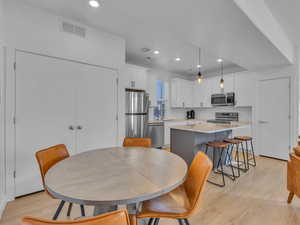 Dining room featuring light wood-type flooring and recessed lighting