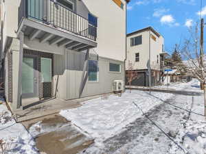 Snow covered property featuring a balcony and board and batten siding