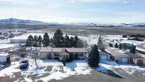 Snowy aerial view featuring a mountain view