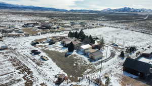 Snowy aerial view featuring a mountain view and a residential view