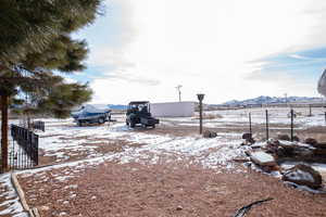 Snowy yard featuring a mountain view