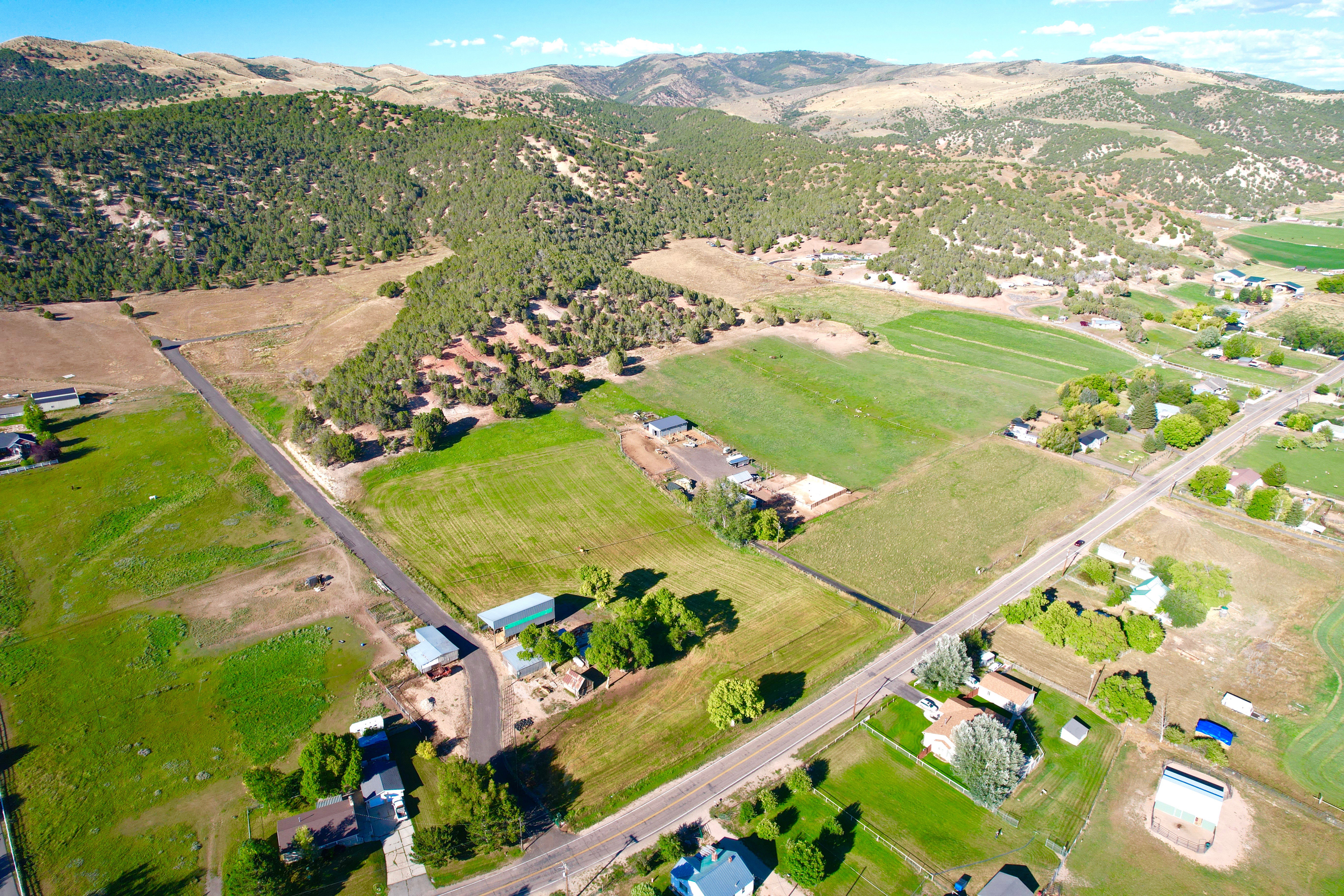 Aerial view of property's location featuring a mountainous background and rural landscape