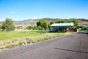 View of asphalt road featuring a mountain view and a view of rural / pastoral area