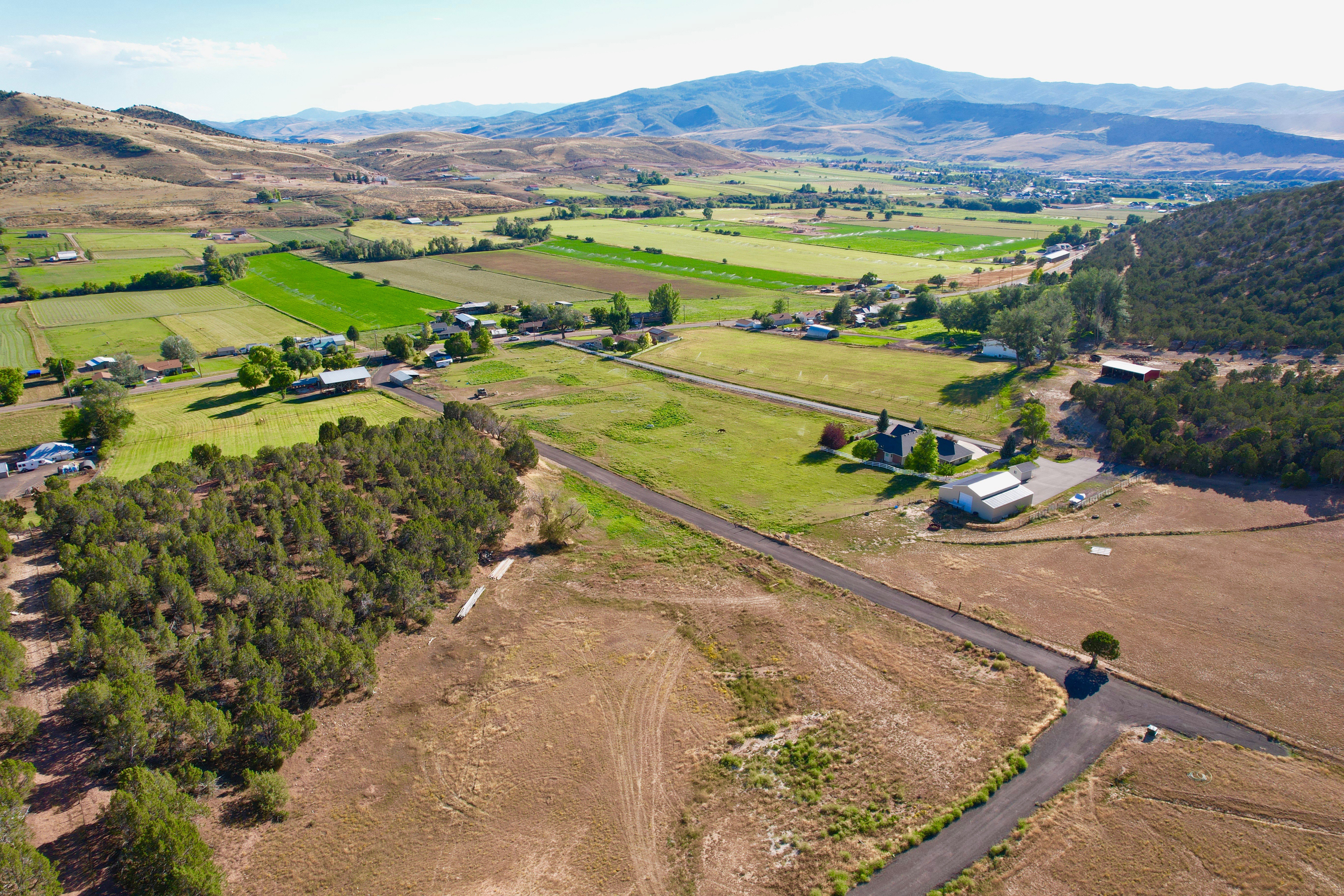 View of property location with rural landscape, a mountainous background, and rows of crops