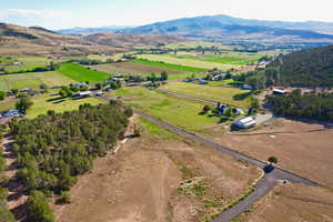 View of property location with rural landscape, a mountainous background, and rows of crops