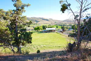 View of mountain backdrop featuring rural landscape