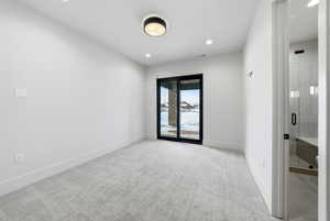 Empty room featuring light colored carpet and recessed lighting