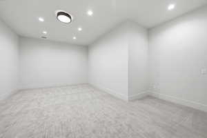 Unfurnished room featuring light colored carpet and recessed lighting