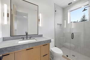 Full bath featuring vanity and a shower stall
