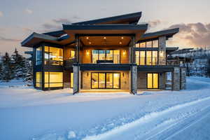 Snow covered property with a balcony