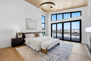 Bedroom featuring a high wood ceiling, light wood-style floors, access to outside, and recessed lighting