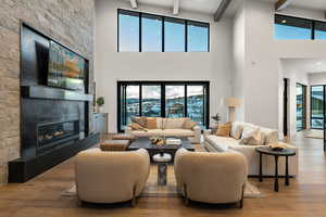 Living area featuring a fireplace, wood finished floors, and beam ceiling