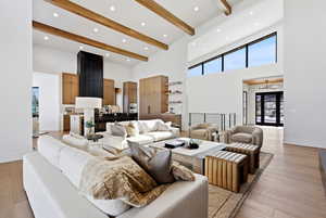 Living room with light wood-style flooring and recessed lighting